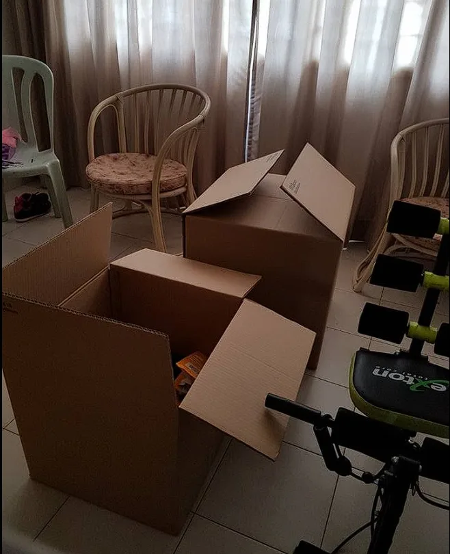Open moving boxes in a living room during a house move
