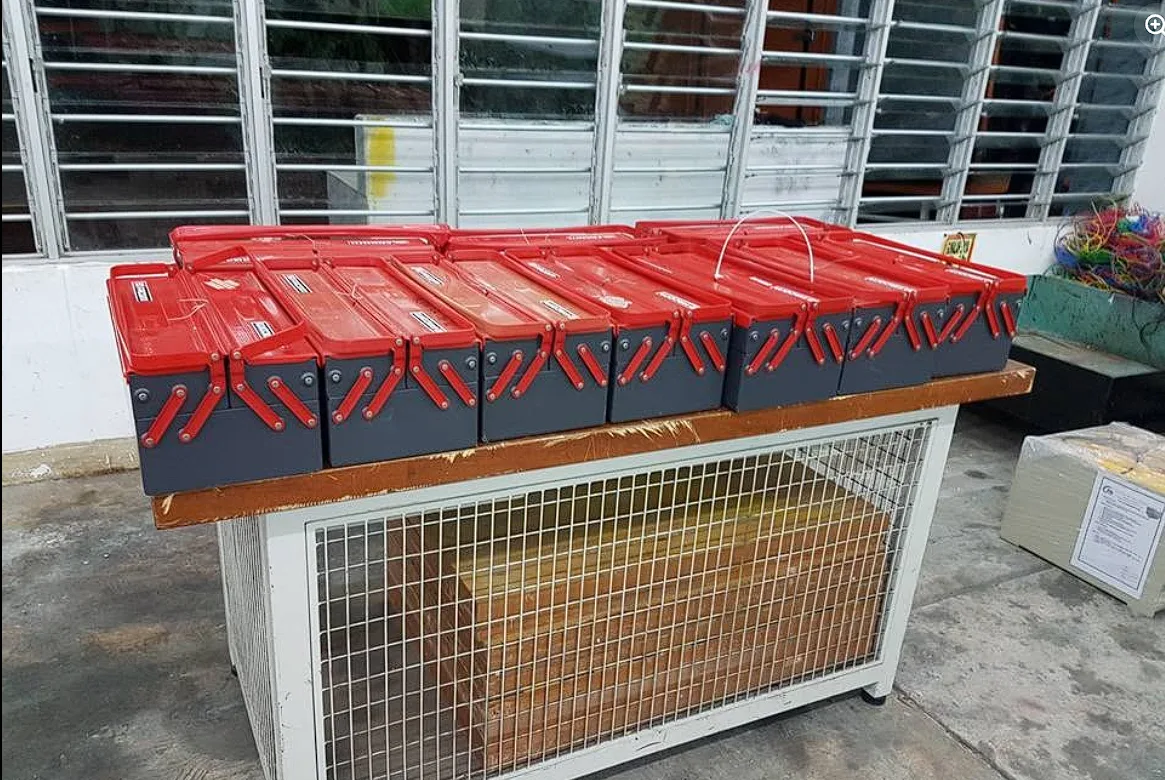 Rows of red toolboxes and workshop equipment prepared for a move