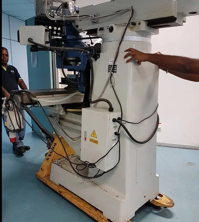 Milling machine mounted on moving skates inside a workshop