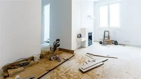 Bright room under renovation with flooring materials and tools on the floor