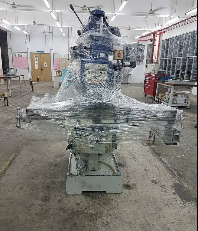 Milling machine fully shrink-wrapped for transport in a workshop