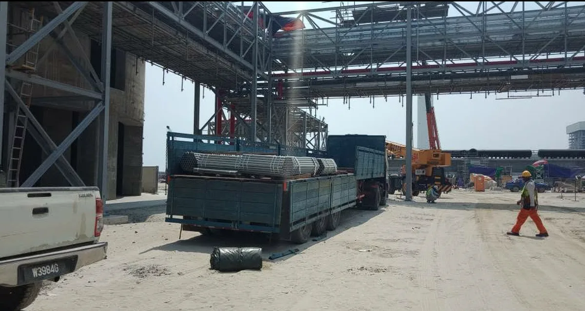 Lorry delivering steel pipes to a construction site, freight Port Klang